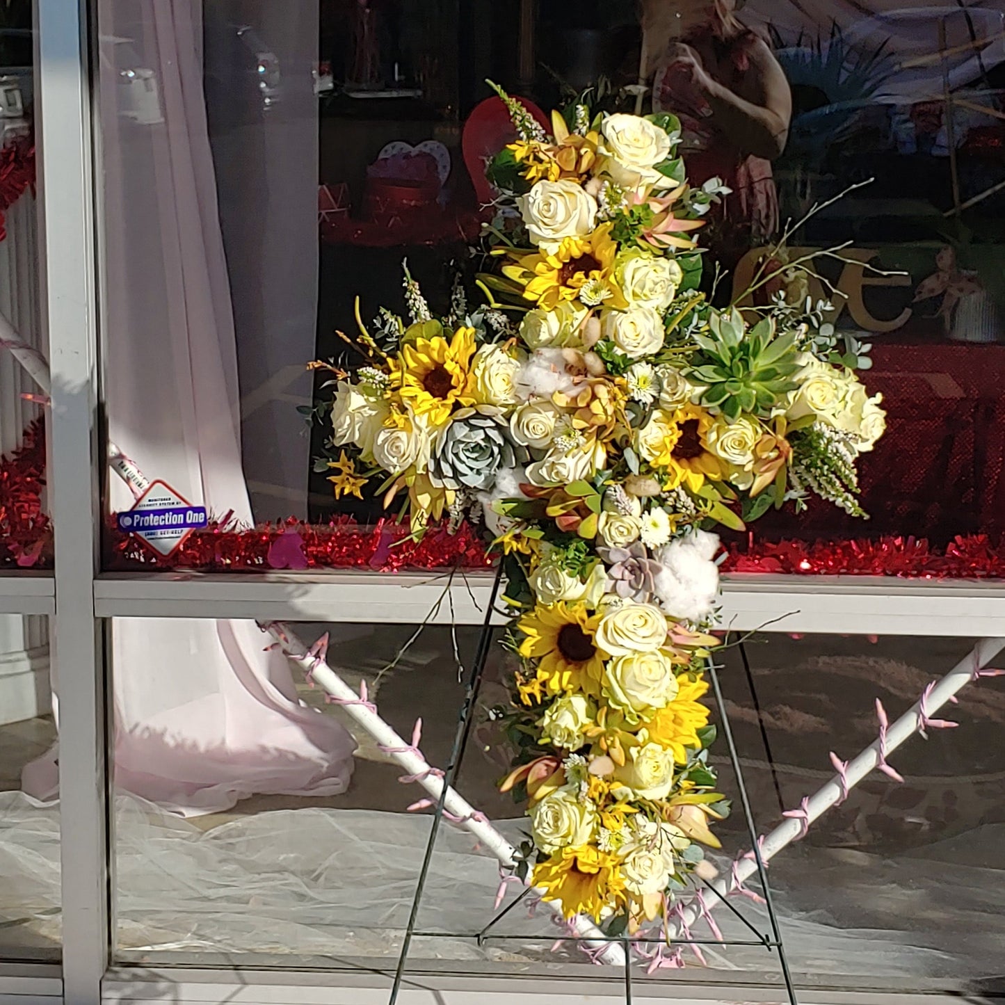 Yellow Cross Sympathy arrangement